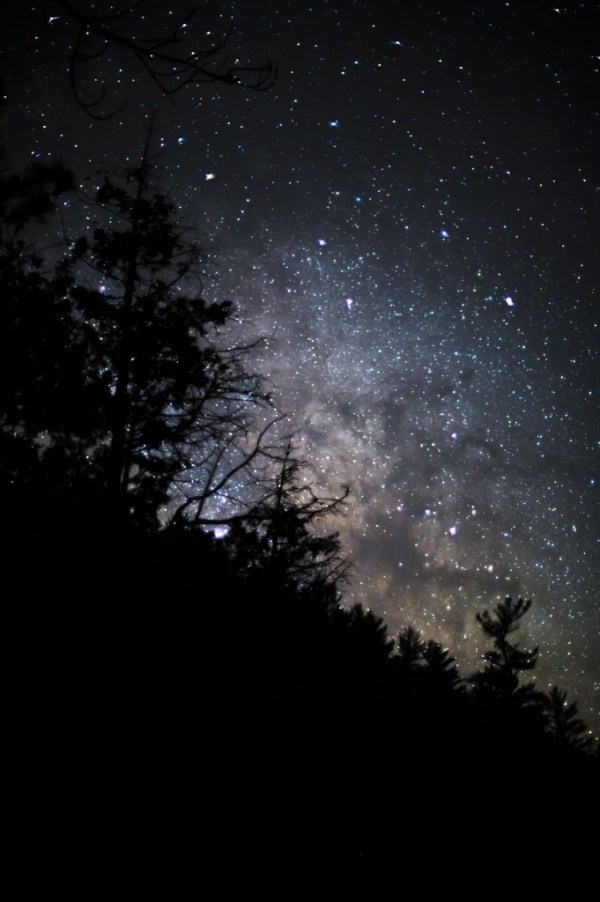 Milky Way and tree line. Nikon Df camera, Nikkor 55mm f/1.2 lens. Photo by Chuck Miller.